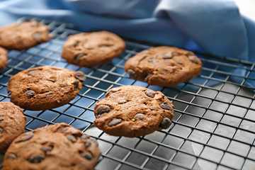 Delicious oatmeal cookies with chocolate chips on metal grid, close up