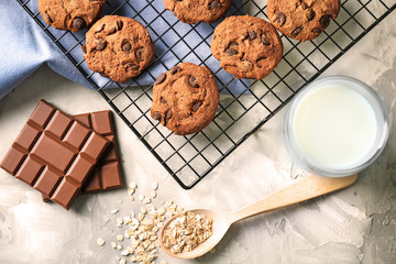 Delicious oatmeal cookies with chocolate chips on metal grid