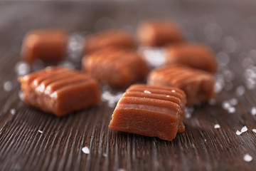 Salted caramel candies on wooden table