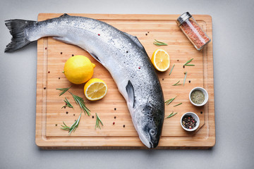 Board with fresh raw salmon on table