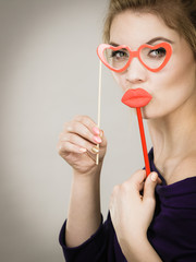 woman holds carnival accessories on stick