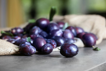 Fresh delicious plums on table, closeup