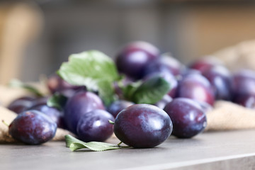 Fresh delicious plums on table, closeup