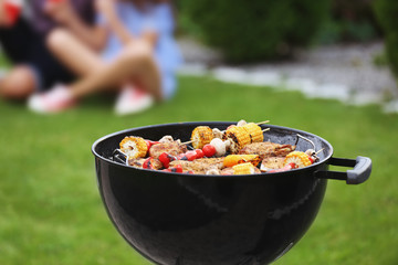 Tasty steaks and vegetables cooking on barbecue grill, outdoors