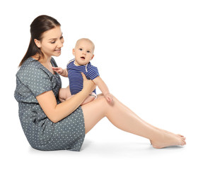 Happy young woman with cute baby on white background