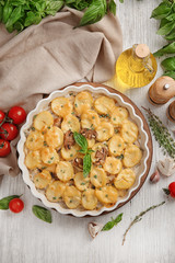 Baking dish with potato casserole on table