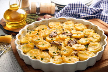 Baking dish with potato casserole on table