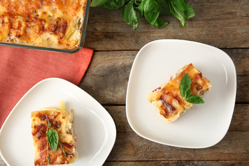 Plates with potato casserole on table
