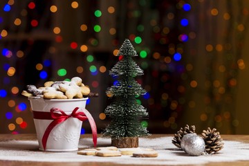christmas table decoration with cookies, christmas tree and pinecones
