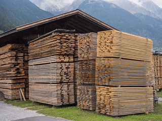 View wood planks stacked in huge piles in sawmill factory.