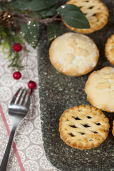 Mince pies on a tray with festive christmas decorations