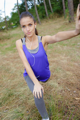 young woman exercising in forest