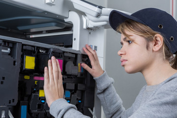 female technician fixing a printer
