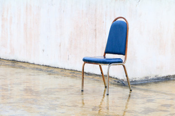 Old chair On the outside building With rain