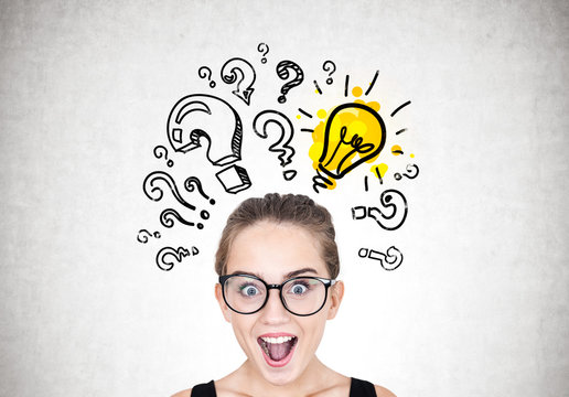 Astonished girl in glasses, light bulb, quesitons