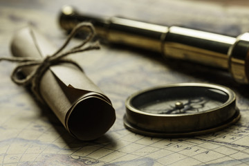 Retro compass with old map and spyglass