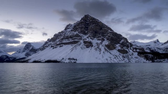 Time lapse of clouds blowing over a mountain peak along Bow Lake in Banff National Park.