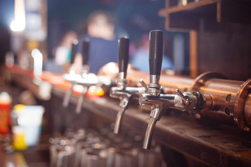 Many beer taps in the beer bar