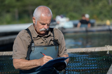 Fototapeta premium portrait of a handsome senior man nest to river