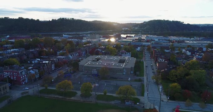 A sunset aerial establishing shot of Pittsburgh's Old Allegheny Rows Historic District. Shot at 48fps.  	