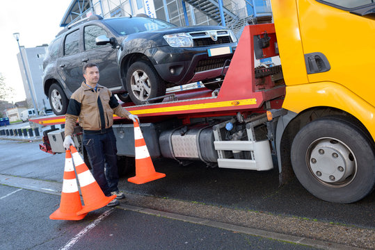 towing truck driver removing road signs