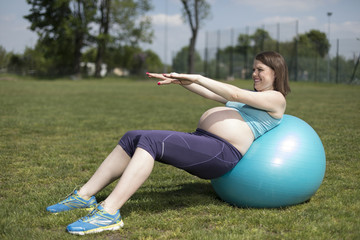 Pregnant woman with fitness ball