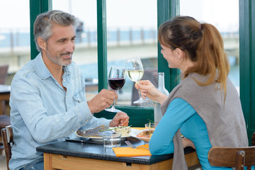 Couple toasting with wineglasses in restaurant