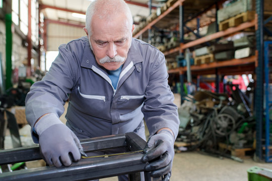 senior mechanic working in a factory