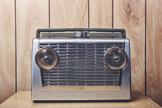 Vintage radio on a wood paneled wall background