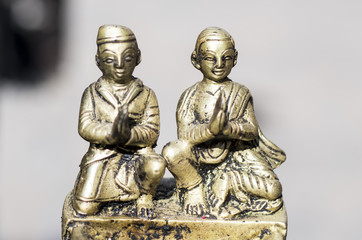 A male and a female metal statue close-up