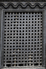 wooden traditional handcrafted window in the brick wall