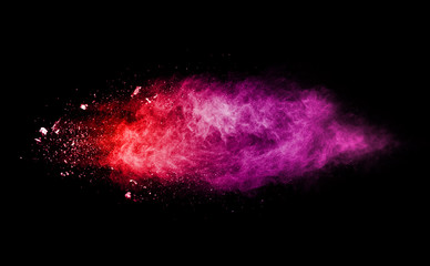Freeze motion of colored powder explosions isolated on black background
