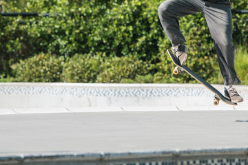 Skateboarder Does Trick Out Of Bowl At Skateboard Park