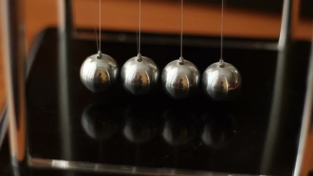 Hand Starting Newtons Cradles