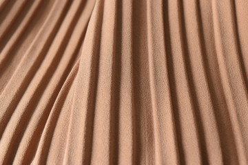 Fototapeta na wymiar Brown pleat fabric background is a beautiful curved wave.