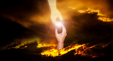 Dramatic atmosphere panorama scene of God's helping hand reach to human saving them from trouble.