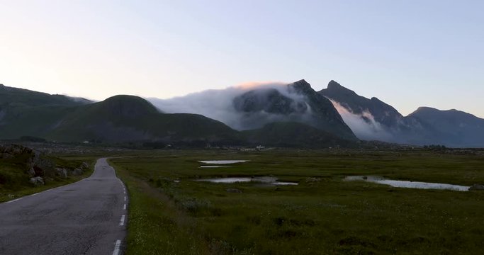 Accelerated footage of fast moving clouds over the Lofoten mountains in arctic Norway during summer
