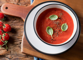Tomato soup on a rustic wooden table