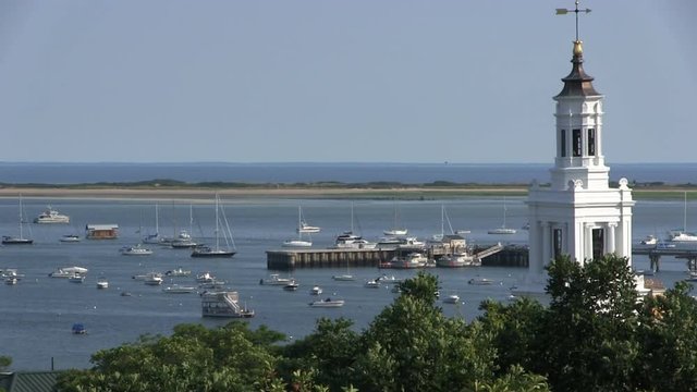Provincetown famous Pilgrim Monument high hill view vista seascape overlook harbor bay dunes moored boats building architecture landscape busy summer tourist season highlight vacation destination