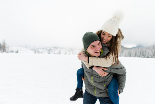 Romantic teen couple having fun in snow