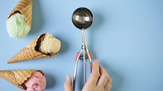 Waffle ice cream cones with scoops of ice cream on a blue background