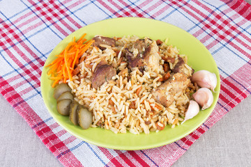 Pilaf with beef, carrots, cucumber, garlic