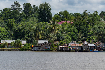 Fototapeta na wymiar Fisherman house on Berau river, Borneo, Kalimantan, Indonesia
