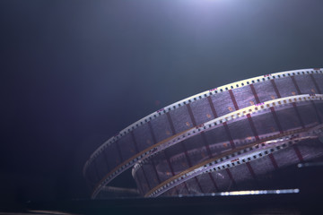 Fototapeta premium Old film with a movie on a dark background