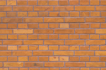 Fototapeta premium New build brick wall texture. Modern construction, surface build from orange and brown bricks.
