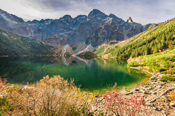 Naklejka na ściany i meble Stunning lake in the mountains at dawn in autumn