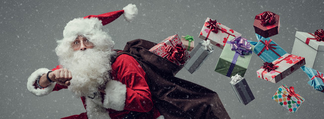 Santa Claus running and delivering gifts