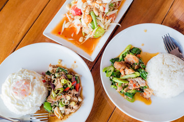 stir-fried pork and herb with rice, Stir fried kale and crispy pork with rice, papaya salad or Som Tum, Thai food