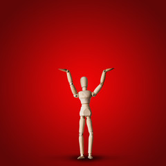 Wooden Mannequin holds hand up on red background