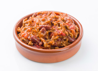 homemade stew of beans and meat in clay pot on white background